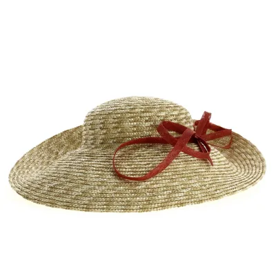 Asymmetrical wide-brimmed hat in natural straw with brick-colored bow